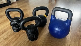 Group of the best kettlebells on a wooden floor during testing