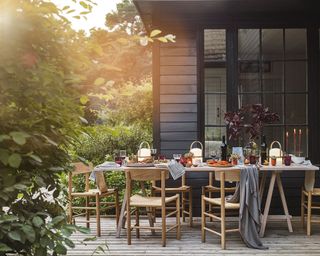 Outdoor fall decor with table setting on deck