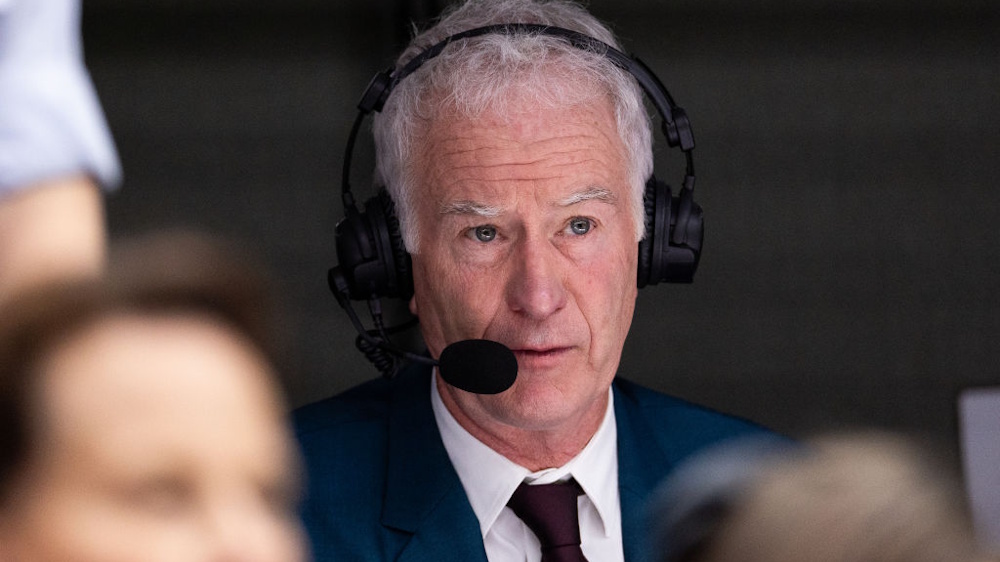 John McEnroe commentating during a Wimbledon tennis match in 2023.