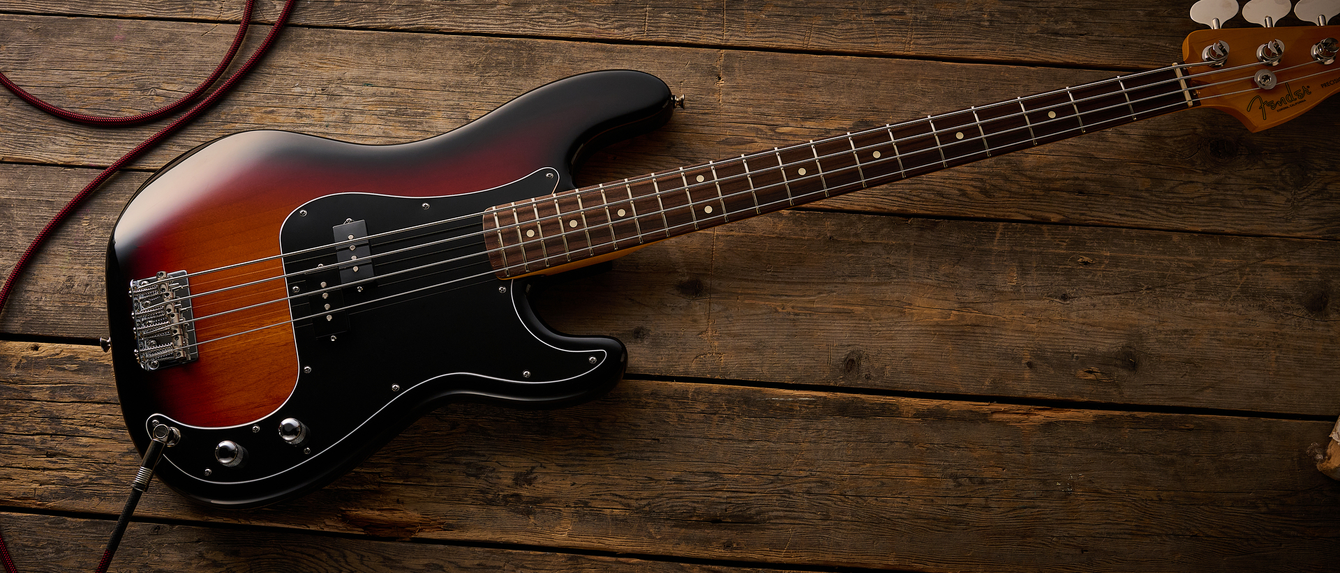 Fender American Professional Classic Precision Bass in 3-Color Sunburst shot on wood floor boards