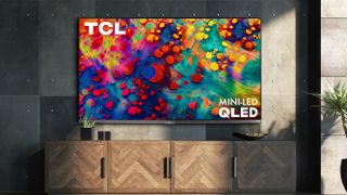 A TCL TV in a grey room with a colourful pattern on the display