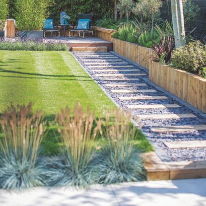 Garden with lawn and a stepping stone path to the side of it