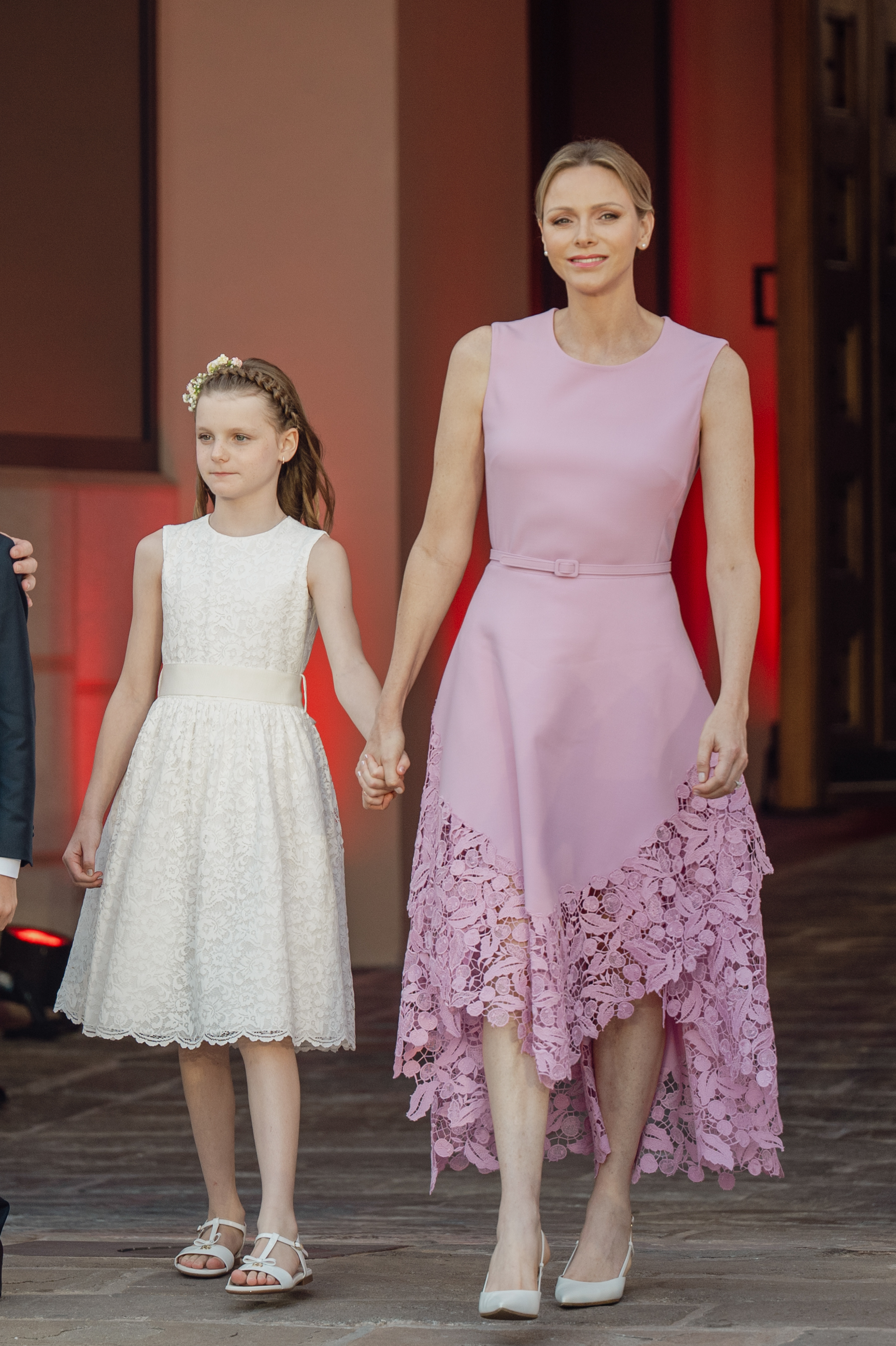 Princess Charlene wears a pink Barbiecore Oscar de la Renta dress and poses with daughter Princess Gabriella