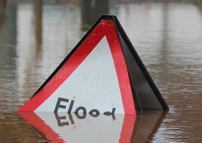 Flooded flood sign, global warming