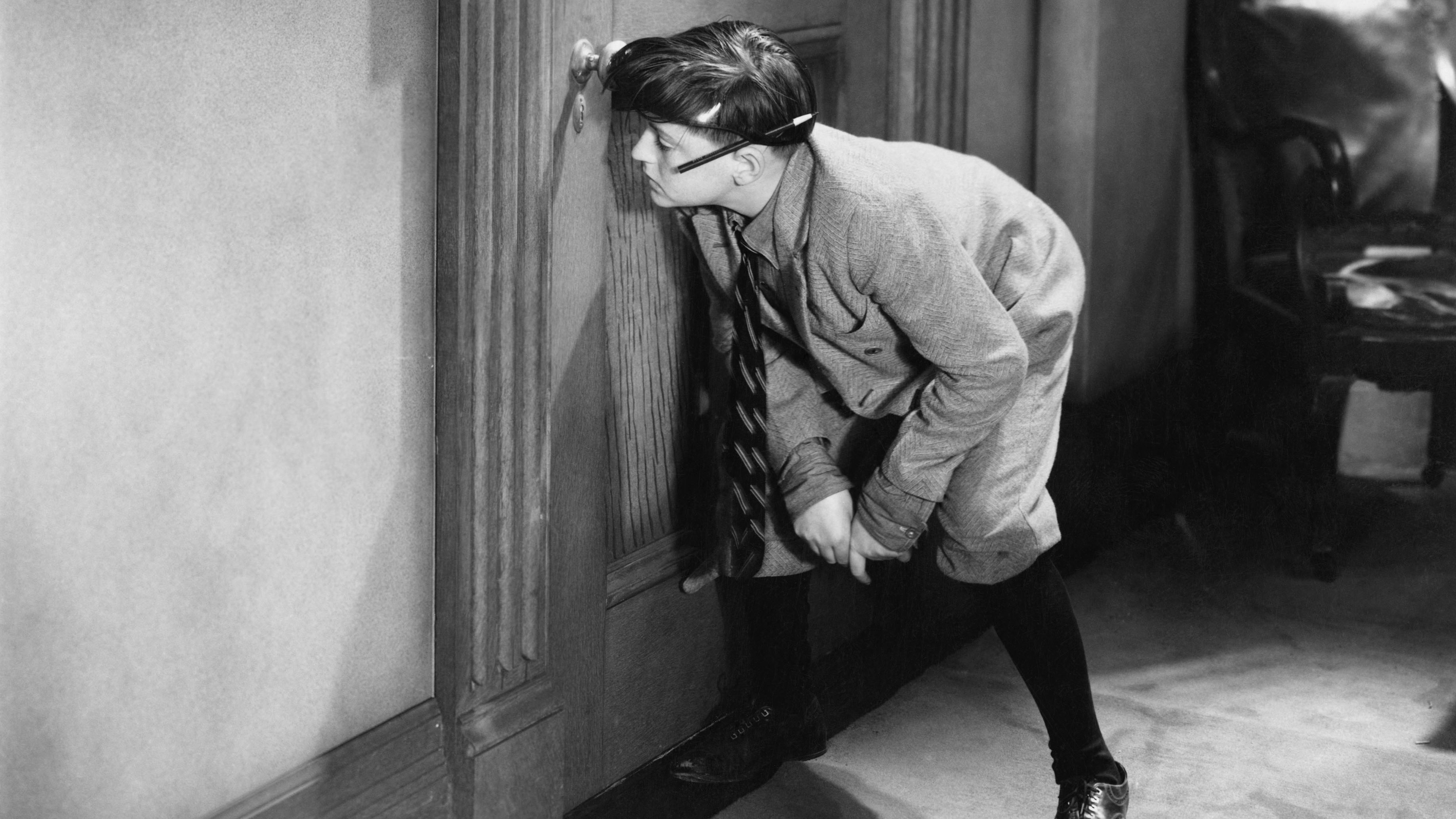 Child eavesdropping and spying through peephole