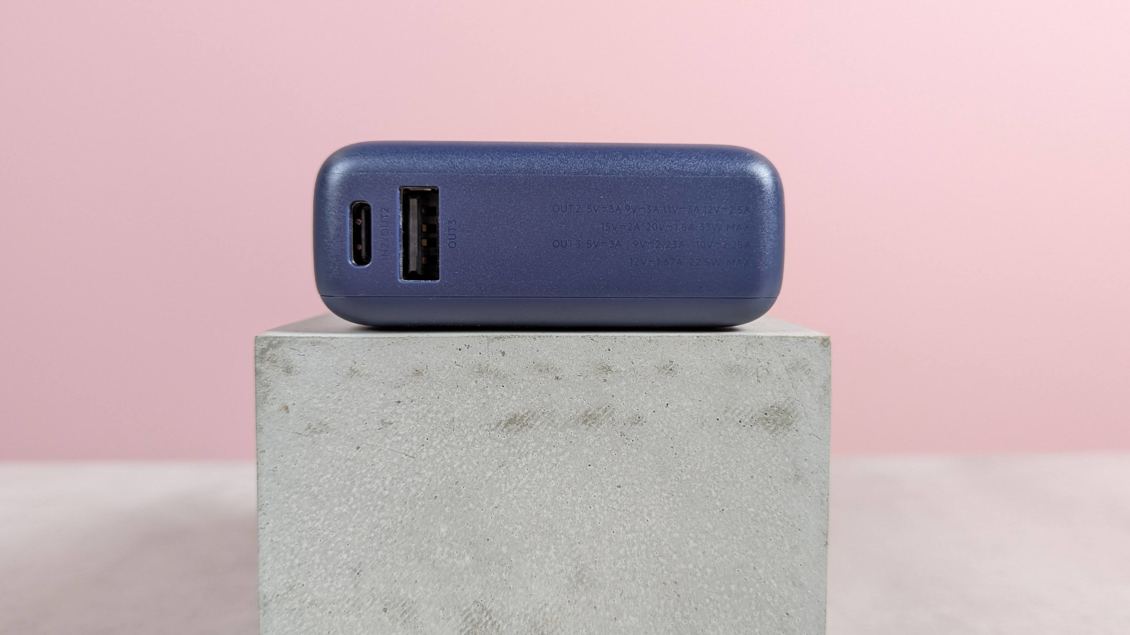 Close-up of the port of Xiaomi 33W 10,000mAh power bank, pink background on the base