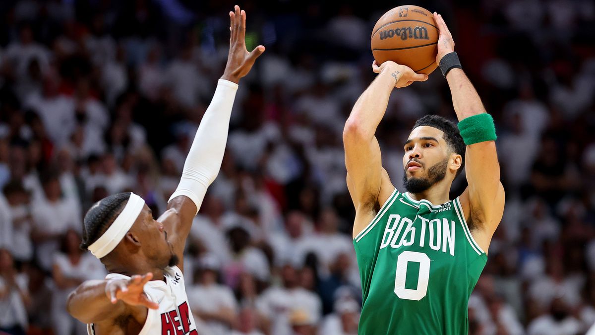 Jayson Tatum #0 of the Boston Celtics shoots the ball over Jimmy Butler #22