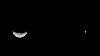 France. Seine et Marne. Nice view of the conjunction between the crescent Moon and the planet Mars (on the right). Photo by Christophe LehenaffImage taken on March 19 2021.