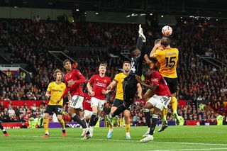 Goalkeeper Andre Onana of Manchester United takes out Sasa Kalajdzic of Wolverhampton Wanderers but VAR decided against awarding the away side a penalty during the Premier League match between Manchester United and Wolverhampton Wanderers at Old Trafford on August 14, 2023 in Manchester, England. (Photo by Robbie Jay Barratt - AMA/Getty Images)