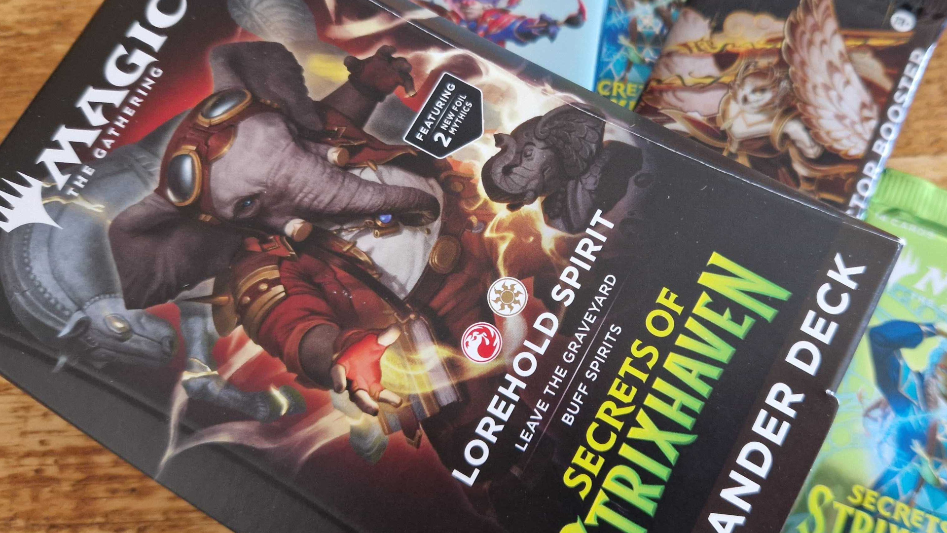 MTG Secrets of Strixhaven Commander deck and boosters on a wooden table