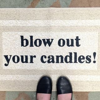 cream colour doormat with text blow out your candles