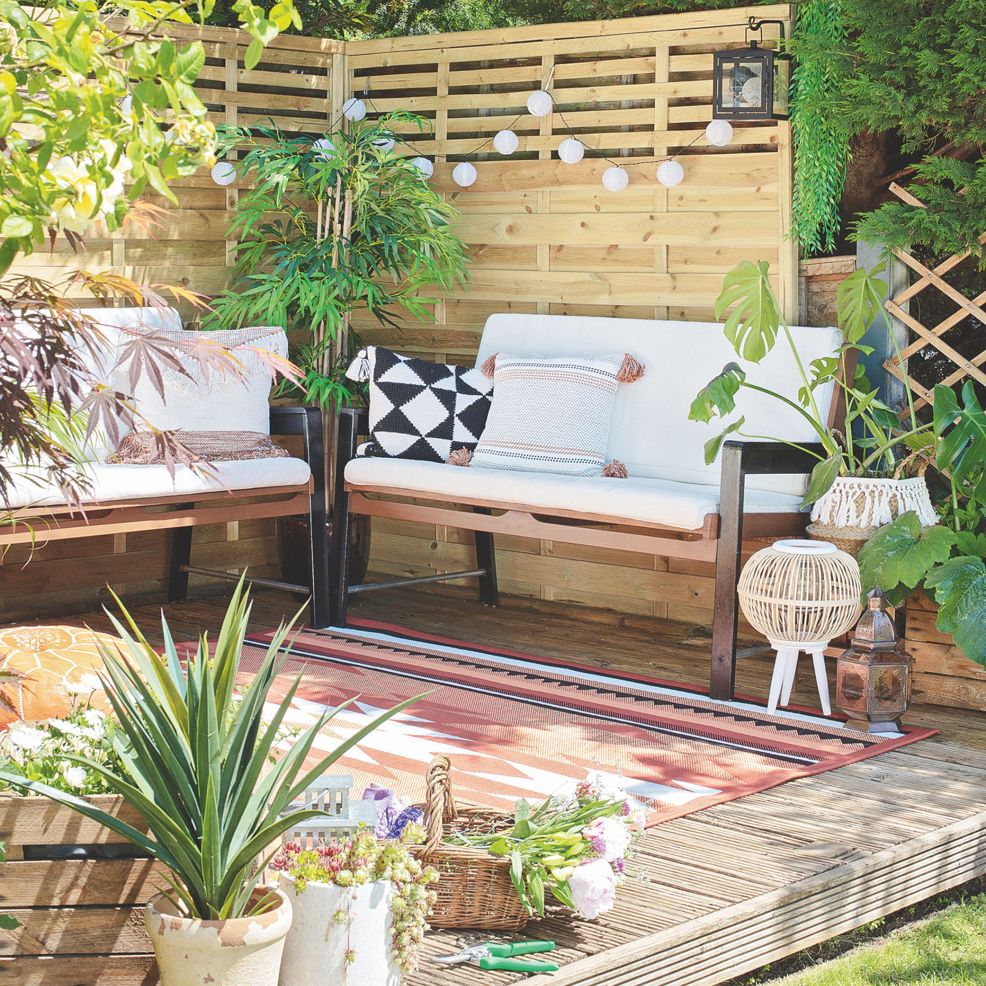 Outdoor decking area with garden furniture and plant pots on it