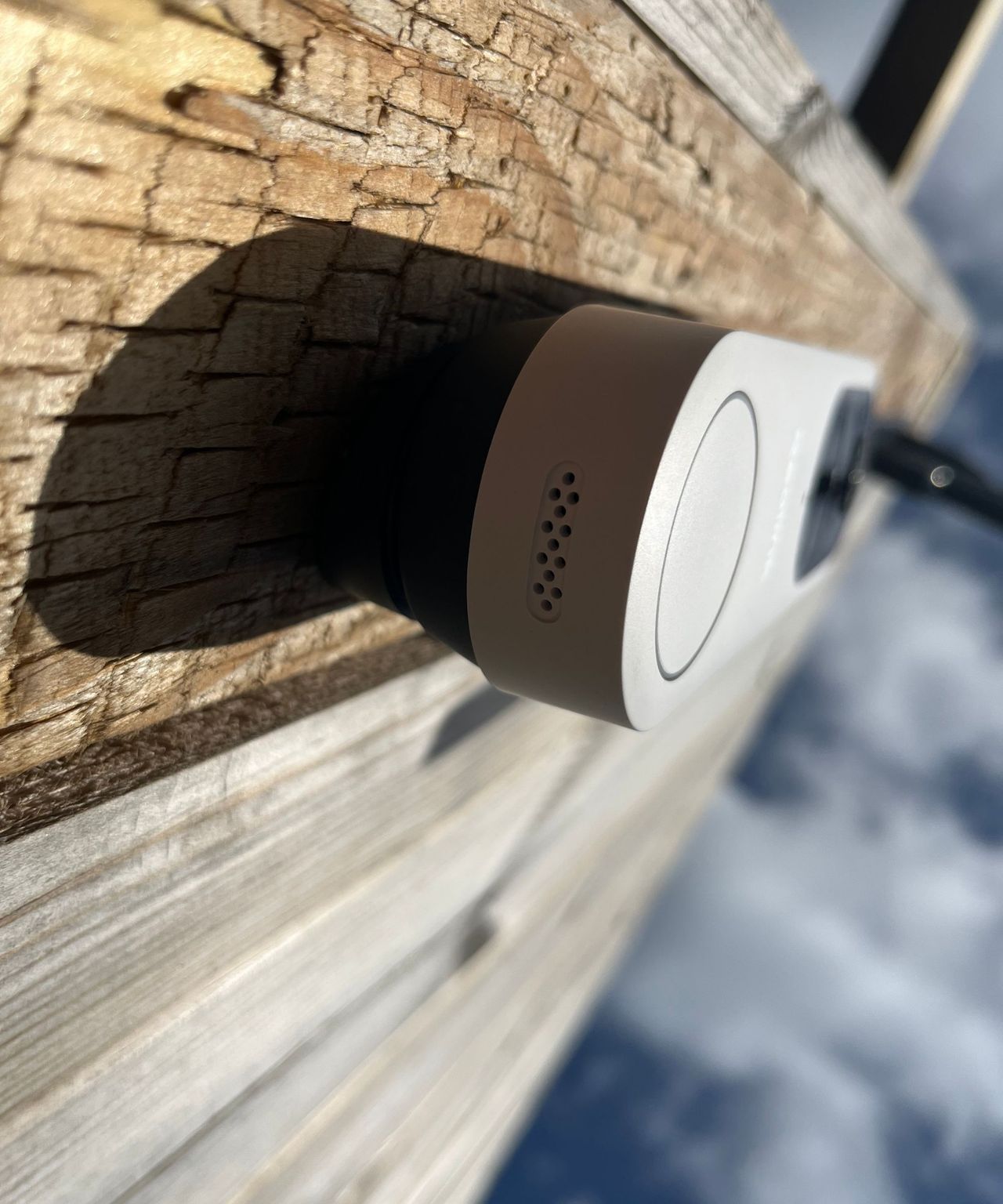View underneath the Reolink video doorbell (battery) attached to fence, looking at the speaker