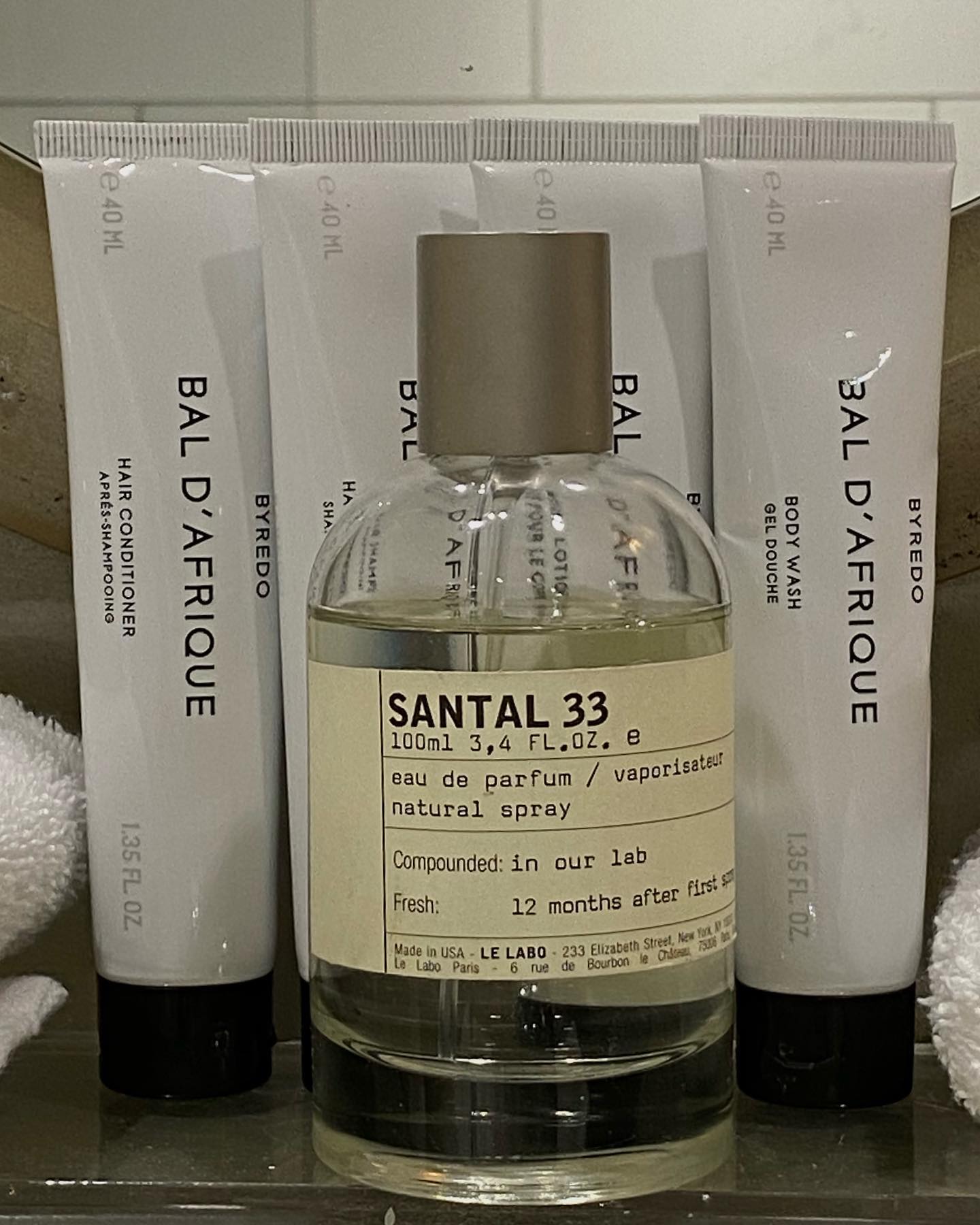 A picture of Le Labo Santal 33 on a shelf with Byredo hand creams