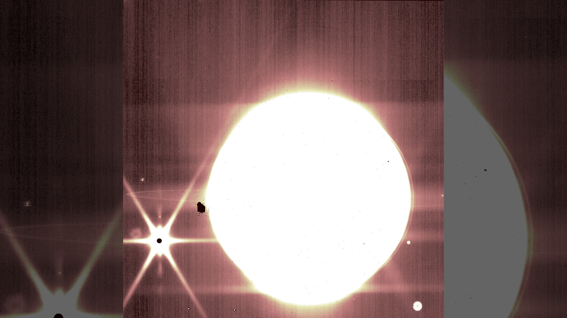 Jupiter and some of its moons are seen through the James Webb Space Telescope's NIRCam 3.23 micron filter.