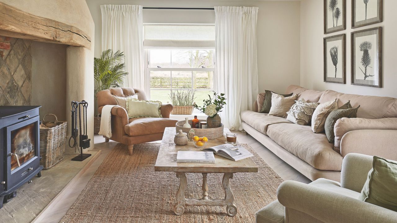 Beige neutral living room with log burner and large wooden windows at the end of the room