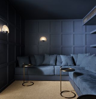 dark blue living room with wood panelling on the walls