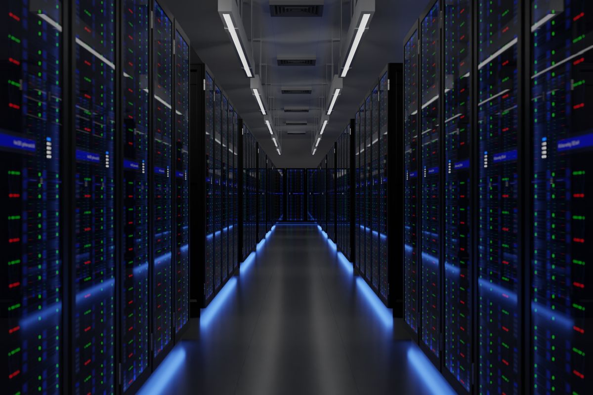 A stock image of a data center server room with dark colored servers featuring blue lights