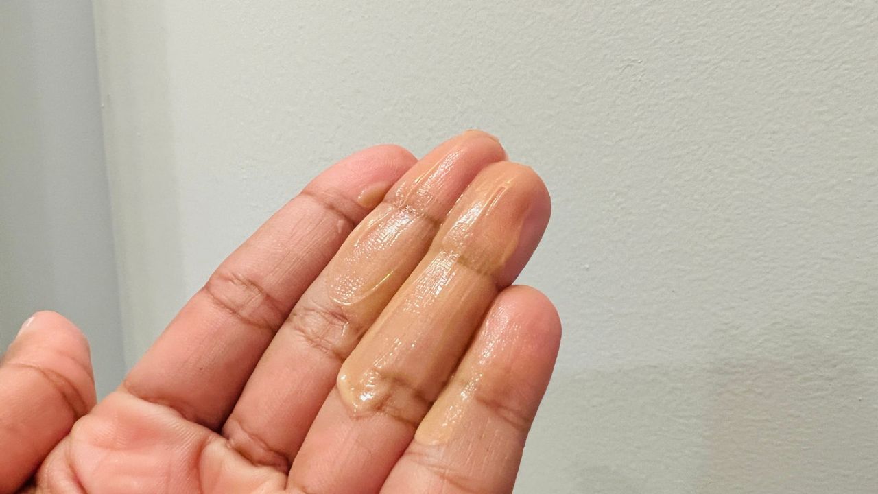 Drunk Elephant Bronzing drops on a person's hand showing its consistency, for w&amp;h's Drunk Elephant Bronzing Drops review.