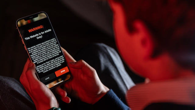 A child attempting to access an age-restricted website, but being blocked