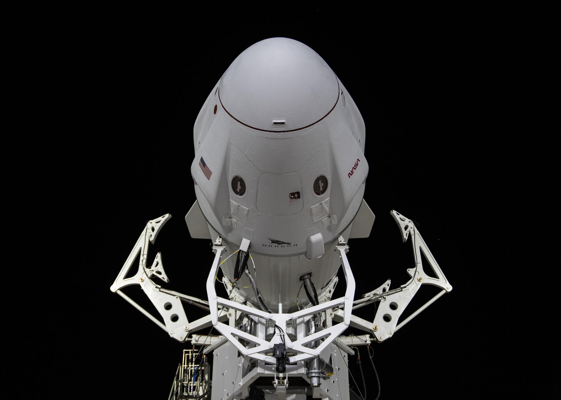 A spacex crew dragon capsule atop a Falcon 9 rocket