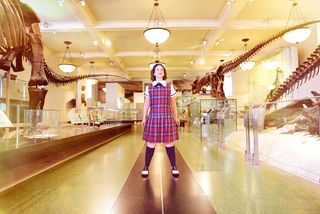 "Rhoda" (soprano Jennifer Zetlan) contemplates a hall teeming with dinosaur fossils at the American Museum of Natural History.