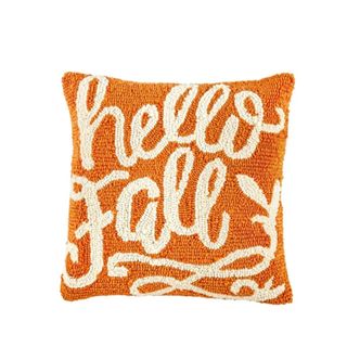 An orange throw pillow that says 