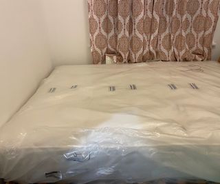Woolroom Hebridean 3000 Mattress in plastic wrap on a bed.