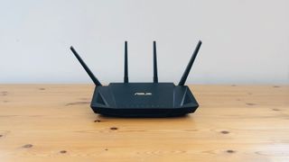 best Asus router Asus RT-AX58U on a wood desk