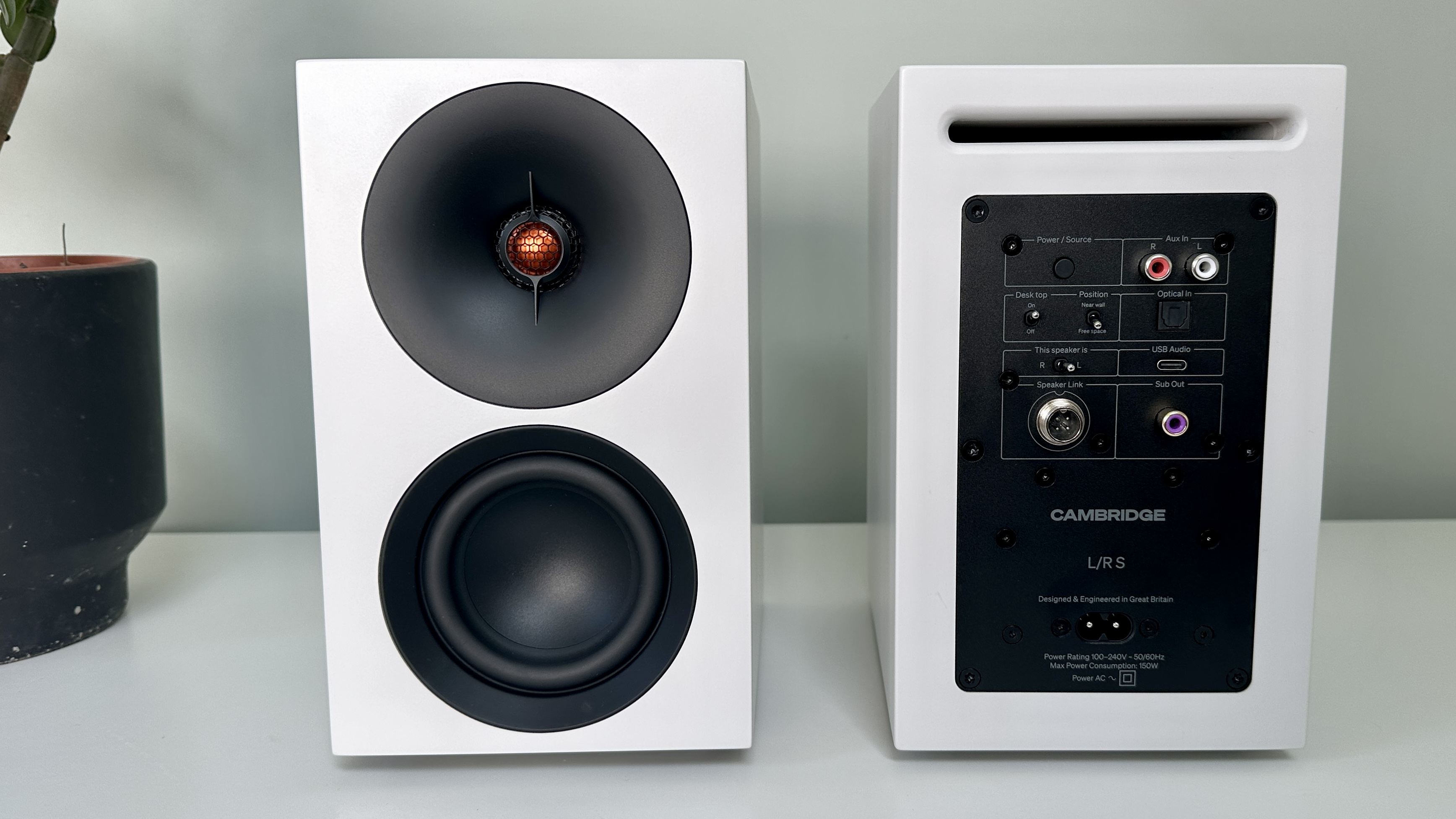 Front and back panels of the Cambridge L/R S active speaker system, on a white surface.