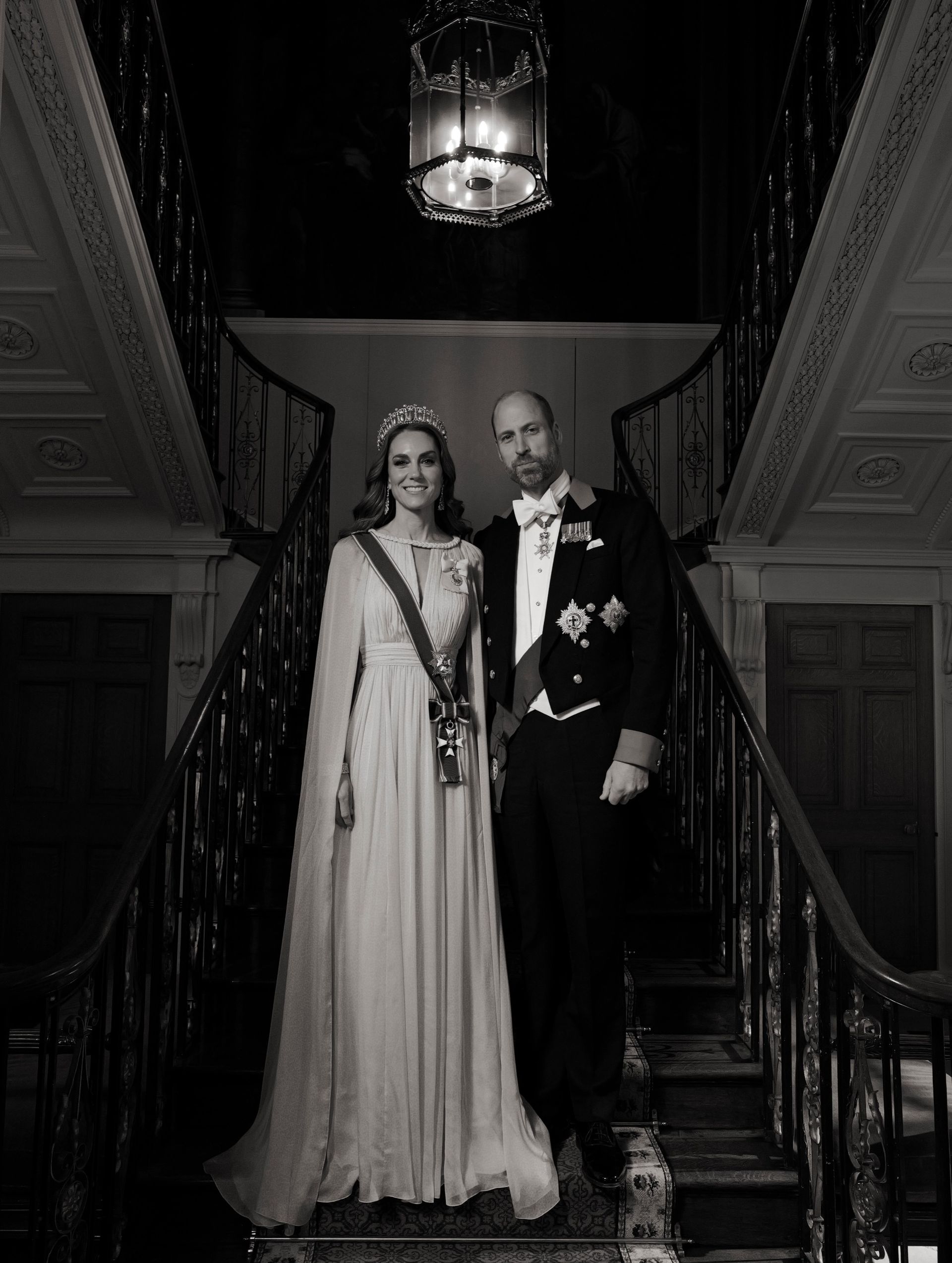 Princess Kate posing on a staircase with Prince William