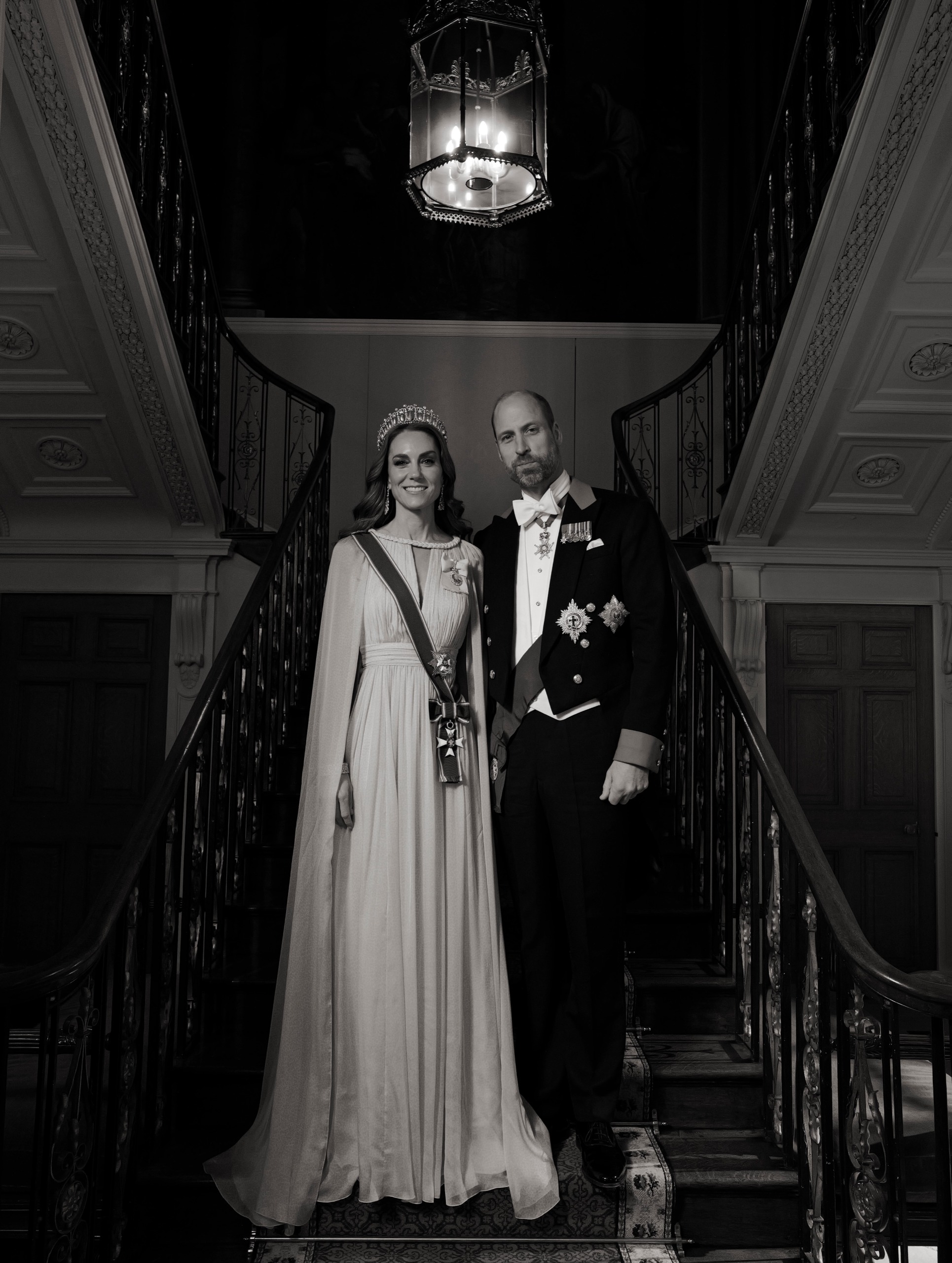Princess Kate posing on a staircase with Prince William