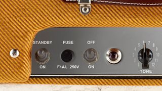 Close up of the Fender '57 Tweed Deluxe tone control, fuse and jewel