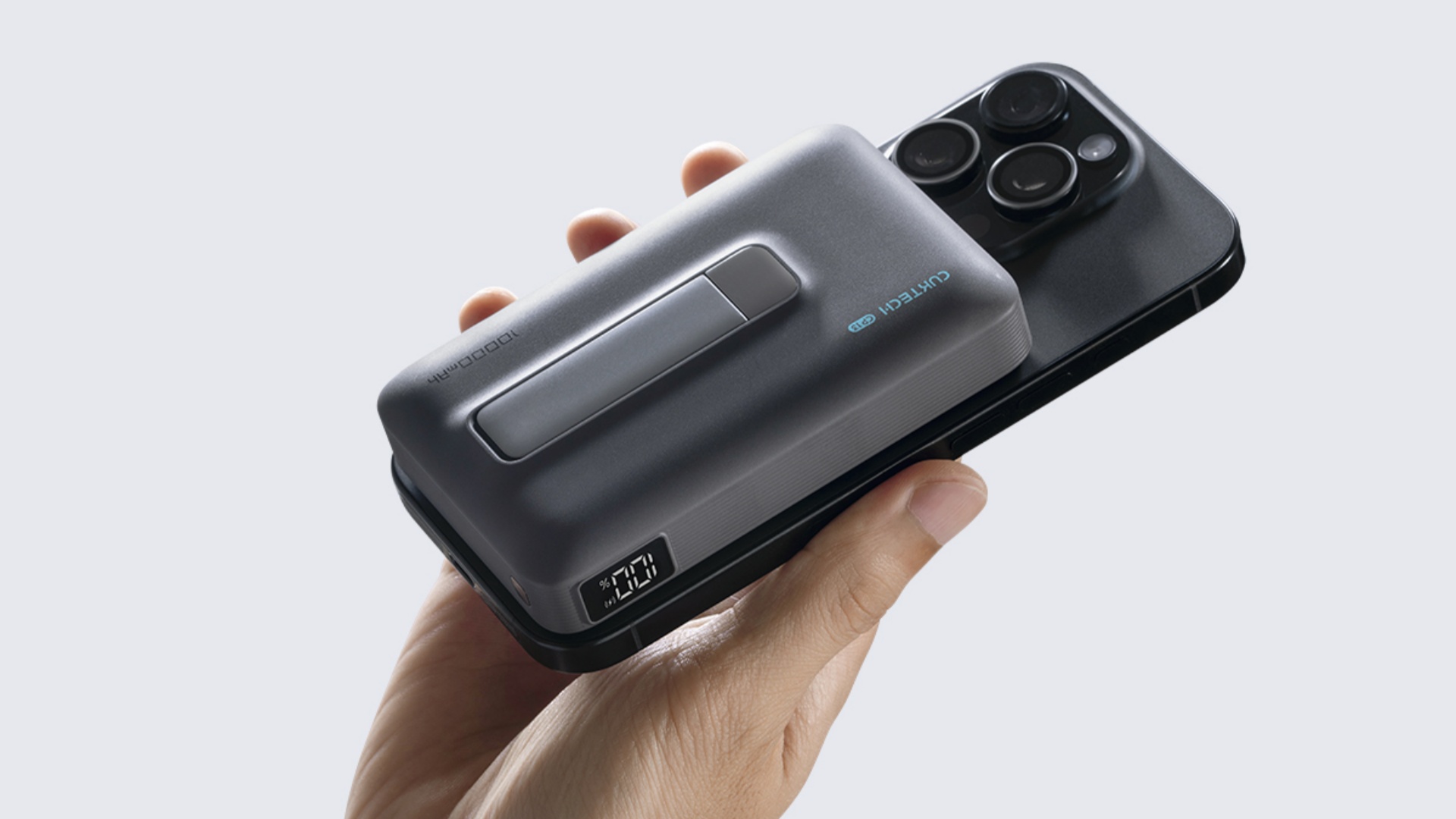 A hand holding the CUKTECH Magnetic Power Bank CP13 Qi2