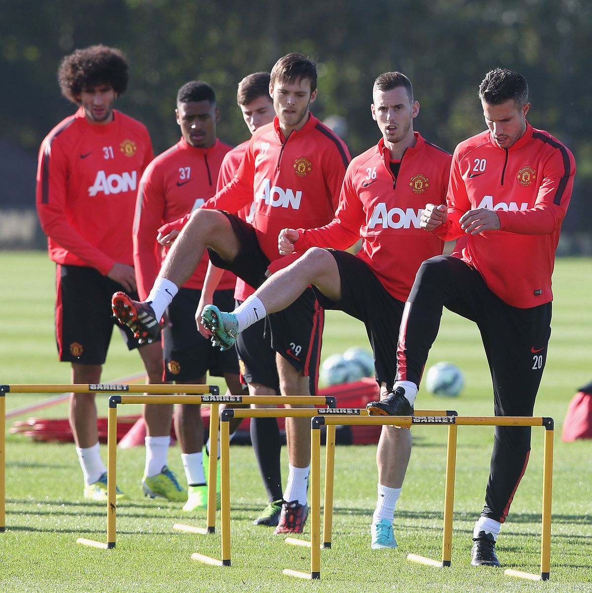 Manchester United trio Robin van Persie, Marnick Vermijl and Tom Thorpe warm-up together at Carrington in 2014