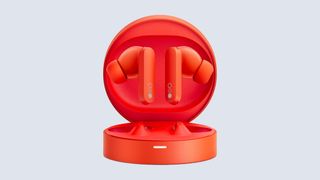 CMF by Nothing; orange earbuds in an orange case