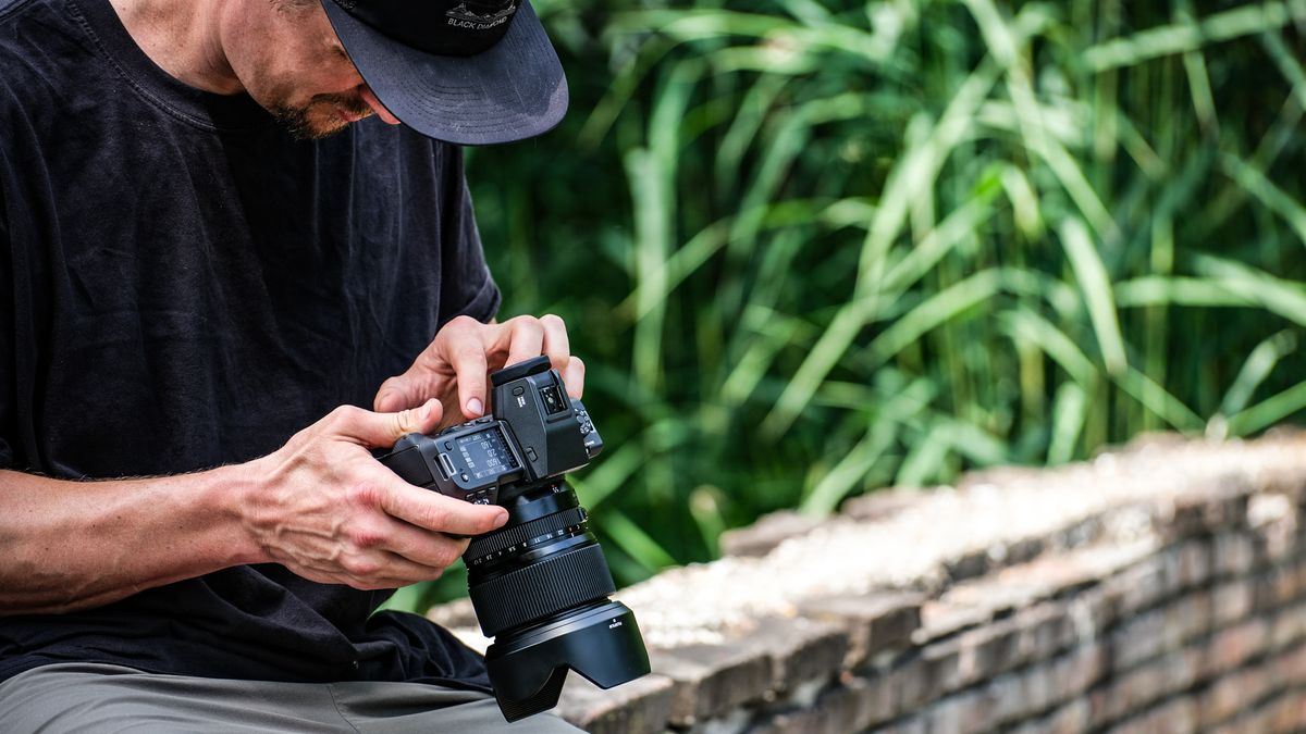 Fujifilm GFX 100 II being used by a photographer outdoors