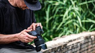 Fujifilm GFX 100 II being used by a photographer outdoors