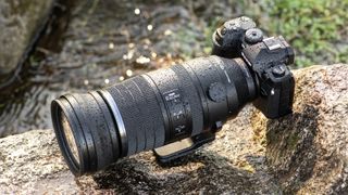OM System M.Zuiko 150-600mm f/5.0-6.3 IS lens pictured outdoors, on a rocky surface
