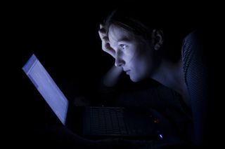 Fear of missing out woman lonely at a laptop