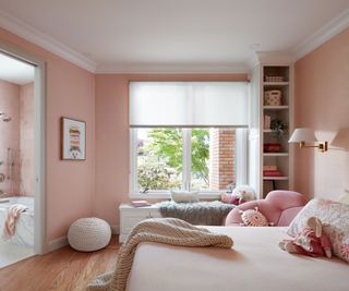 bedroom with pink walls and view to en suite bathroom