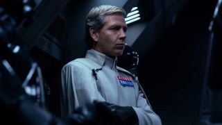 Orson Krennic aboard his shuttle, arms crossed, in Rogue One