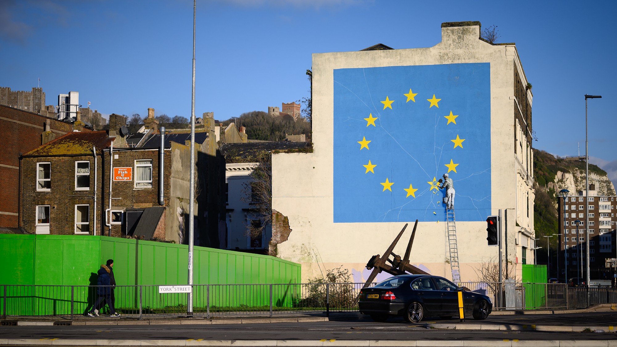 A Banksy mural in Dover depicting a workman chipping away at a star on the EU flag