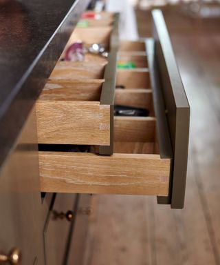 image of two half pulled out drawers, both with dividers and items in