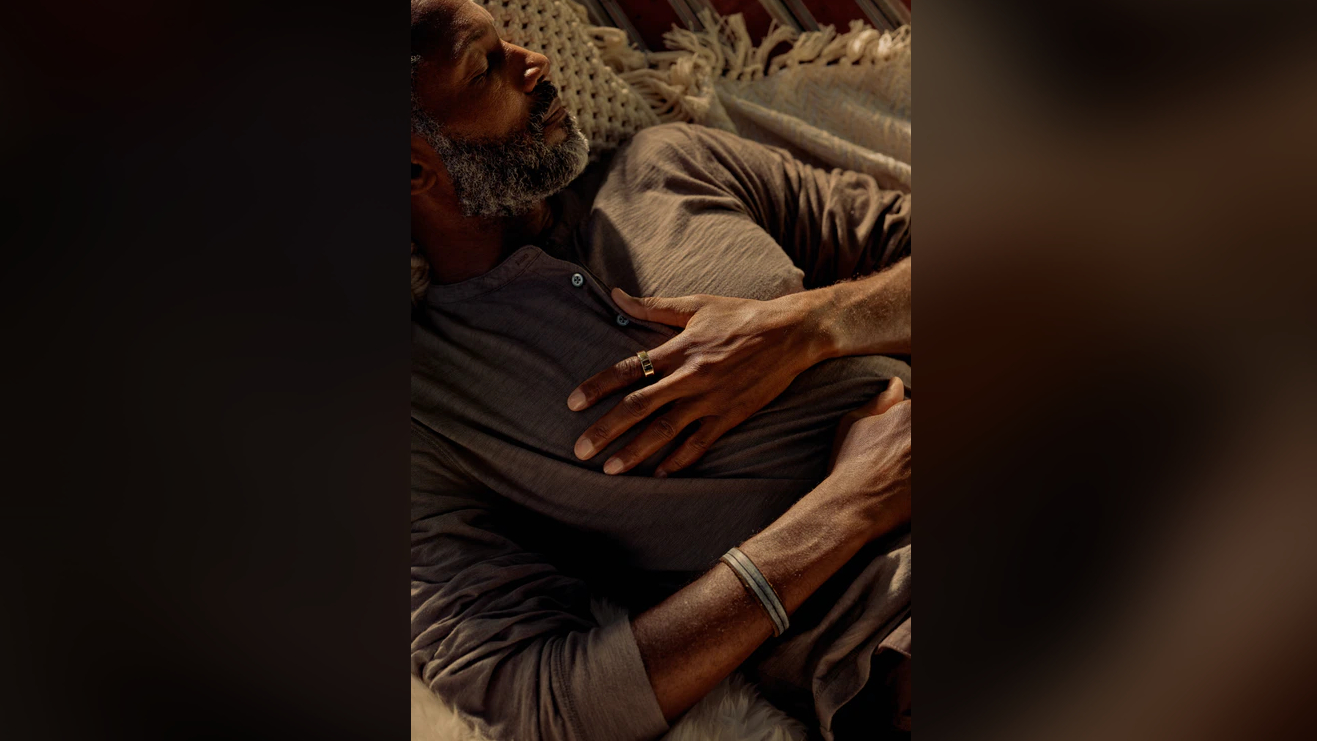 Oura image of man wearing Oura ring while sleeping