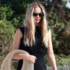 Margot Robbie wore a Jacquemus raffia basket bag and Alaïa mesh ballet flats in Ibiza