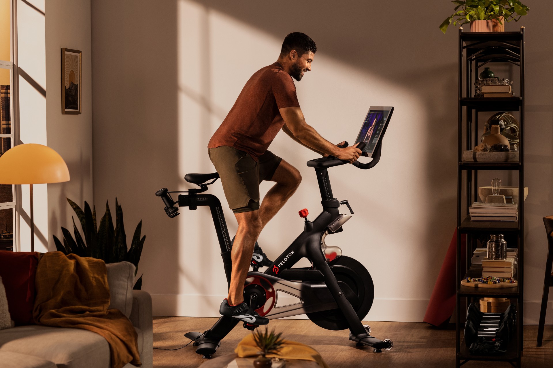 man rides peloton bike