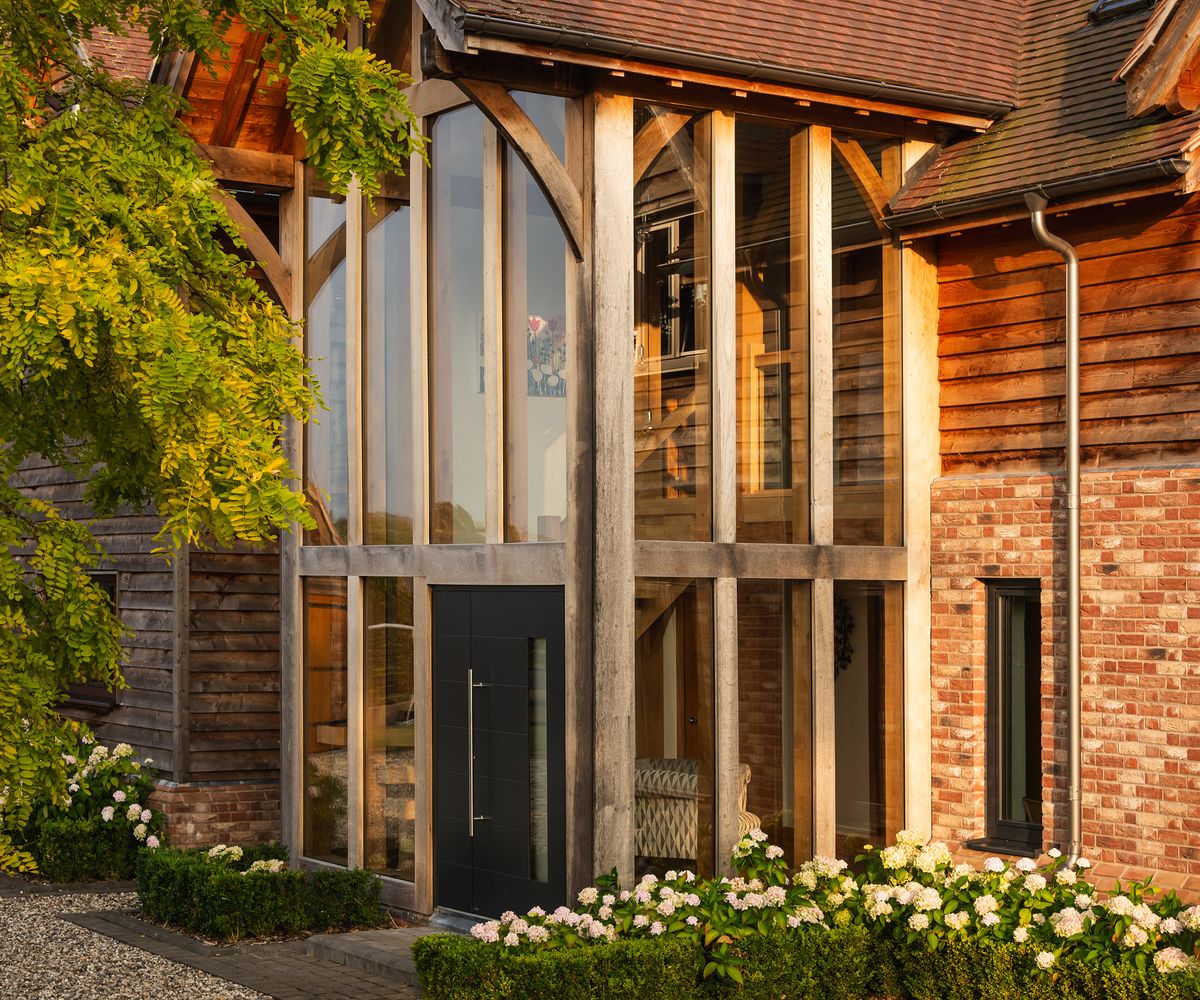 A double height glazed porch/entrance hall in a timber frame self build