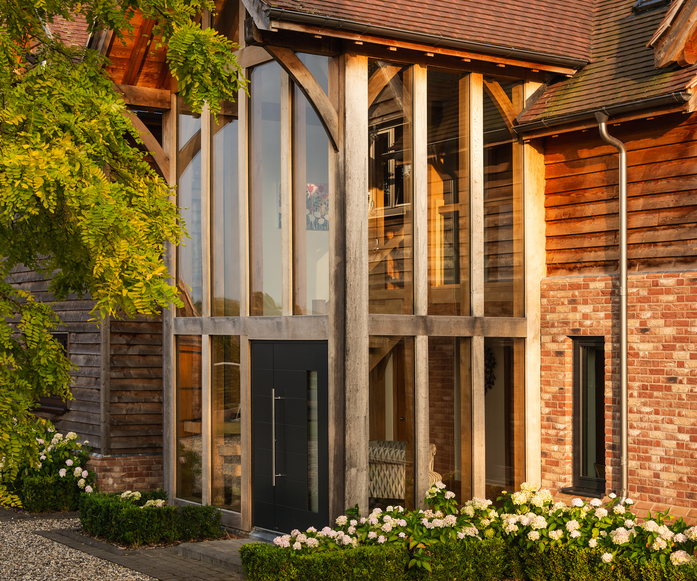 A double height glazed porch/entrance hall in a timber frame self build