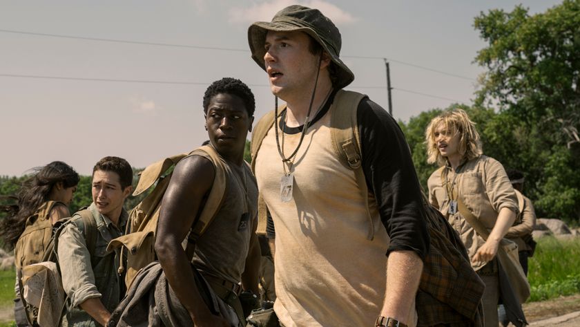 David Jonsson and Cooper Hoffman watch something horrific along with their fellow walkers in The Long Walk. 